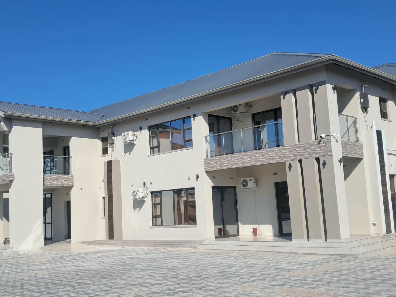 Completed exterior gutter installation on a two-storey residence